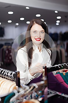 Woman choosing clothes at clothing store