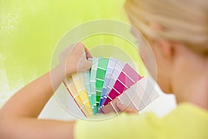 Woman choosing color for wall