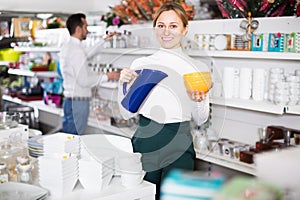 Woman choosing crockery in store