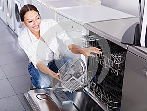 Woman choosing dish washing machine