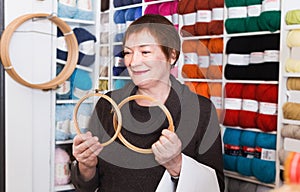 Woman choosing embroidery hoops for fancywork photo