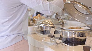 Woman choosing food in buffet in all inclusive resort hotel restaurant. Restaurant food for traditional brunch, lunch