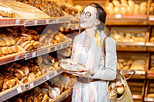 Woman choosing fresh bakery in the supermarket