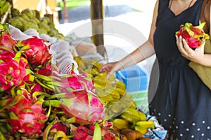 Woman choosing fruits in the open air fruit market