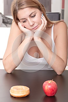 Woman choosing between Fruits and Sweets