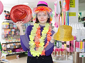 Woman choosing funny headdresses in store