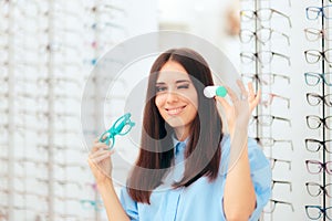 Woman Choosing Between Glasses and Contact Lenses in Optics Shop