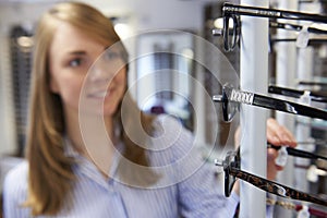 Woman Choosing Glasses In Opticians