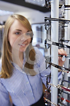 Woman Choosing Glasses In Opticians