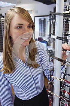 Woman Choosing Glasses In Opticians