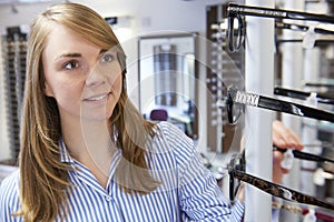 Woman Choosing Glasses In Opticians