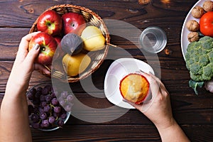 Woman choosing between junk food and fruits