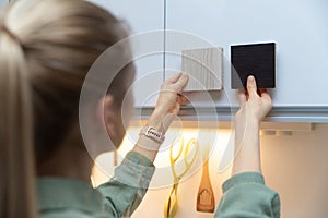 Woman choosing kitchen cabinet materials from laminate samples