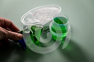 Woman choosing from laundry detergent variety of powder, liquid gel and pod for washing clothes