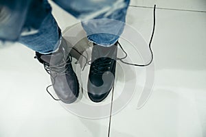 Woman choosing new boots in the shop