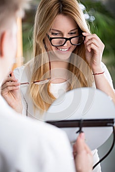 Woman choosing new glasses