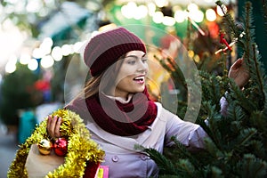 Woman choosing New Year's tree