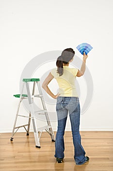 Woman choosing paint color.