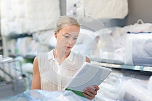 Woman choosing the right item for her apartment in a modern home furnishings store.