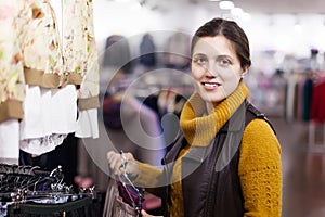 Woman choosing skirt at clothing store