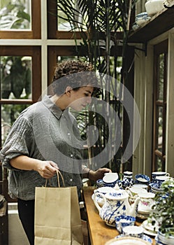 Woman choosing some pottery products for decoration