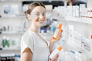 Woman choosing sunscreen lotion at the pharmacy