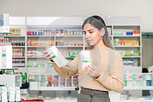 Woman choosing vitamins and supplements for immune system. coronavirus pandemic necessity