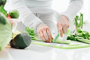 Woman chopping celery