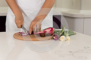 Woman chopping fresh vegetables