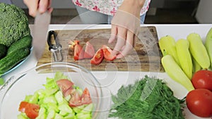 Woman chopping green vegetables for detox smoothie at home. Healthy eating, vegetarian food, dieting