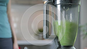 Woman chopping green vegetables for detox smoothie at home. Healthy eating, vegetarian food, dieting