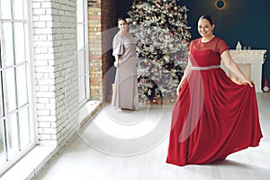 Woman at Christmas. Fat woman in a beautiful dress for a holiday.