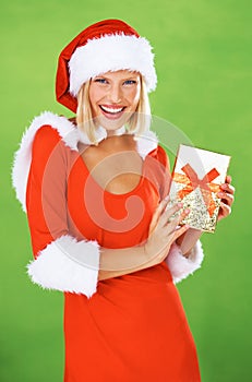 Woman, Christmas and holding gift box in studio holiday giving, festive vacation or smile. Female person, red outfit and