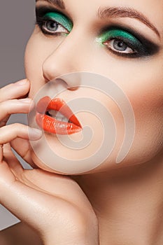 Woman with christmas makeup. Close-up beautiful model face with fashion make-up