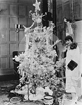 Woman with Christmas tree and gifts