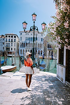 Woman on a city trip to Venice Italy, colorful streets with canals Venice