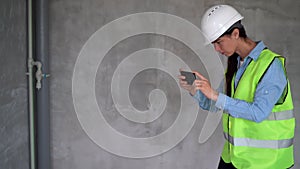 Woman civil engineer making photo work using smartphone at construction site. repair photo report