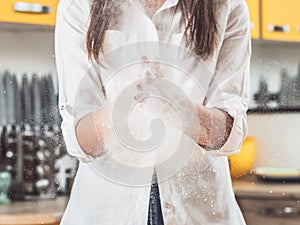 Woman clapping hands flour dust cloud explosion