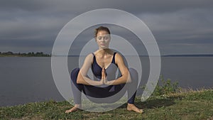 Woman in classical yoga pose, energy concentration