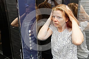 Woman With Claustrophobia In Elevator. Claustrophobia in small space concept