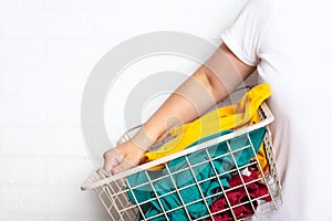 Woman with clean clothes in laundry basket.