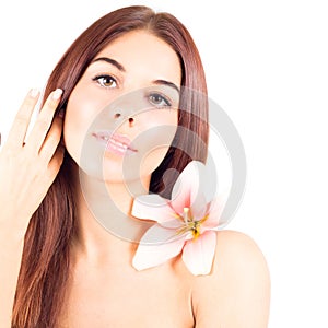 Woman with clean skin and with flower touching hair. Facial result.