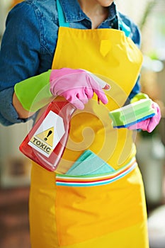 Woman with cleaning agent and sponge