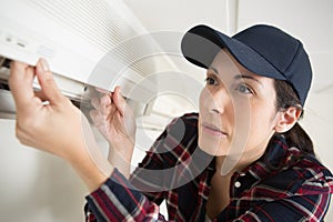 woman cleaning air conditioning