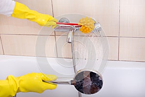 Woman cleaning bathtub