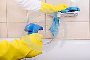 Woman cleaning bathtub