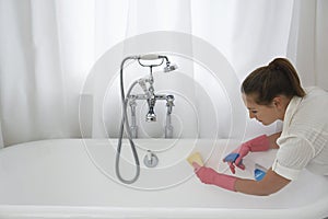 Woman Cleaning Bathtub photo