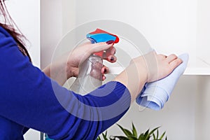 Woman cleaning bookstand