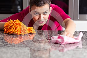 Woman is cleaning countertop