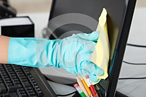 Woman Cleaning Desktop Screen With Rag